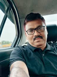 Middle Aged Indian Man Taking Selfie While Travelling In A Car by Stocksy  Contributor Dream Lover - Stocksy